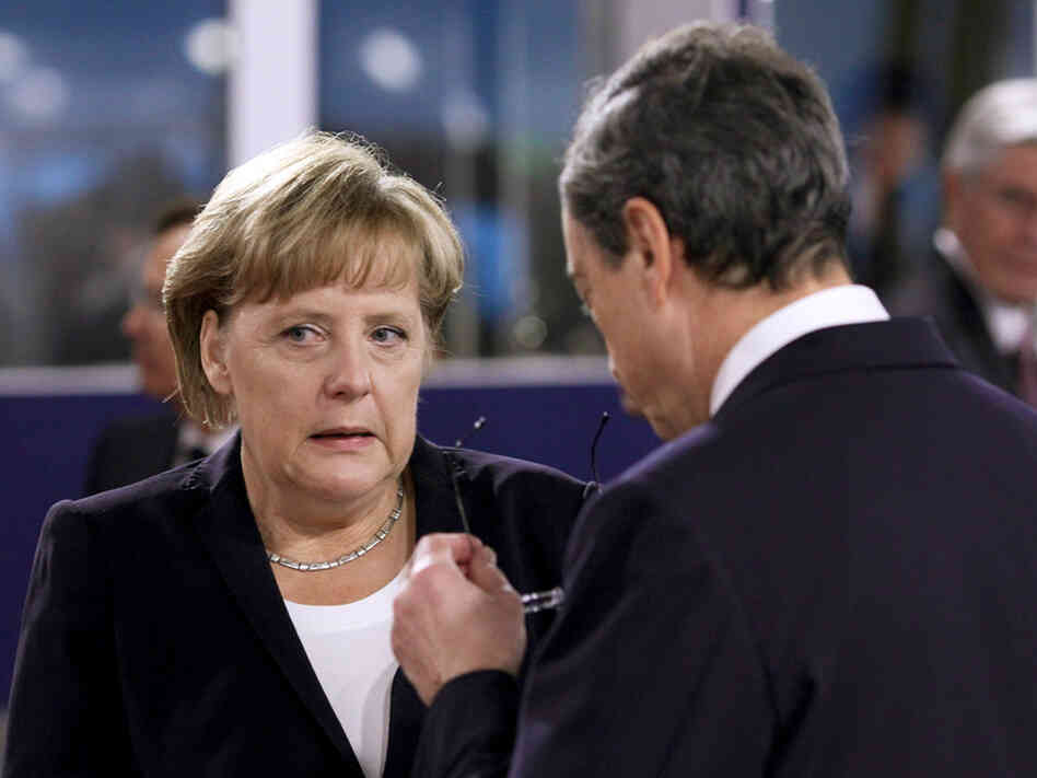 German Chancellor Angela Merkel speaks with Mario Draghi, president of the European Central Bank, on the second day of the G20 Summit in France. German Chancellor Angela Merkel speaks with Mario Draghi, president of the European Central Bank, on the second day of the G20 Summit in France.