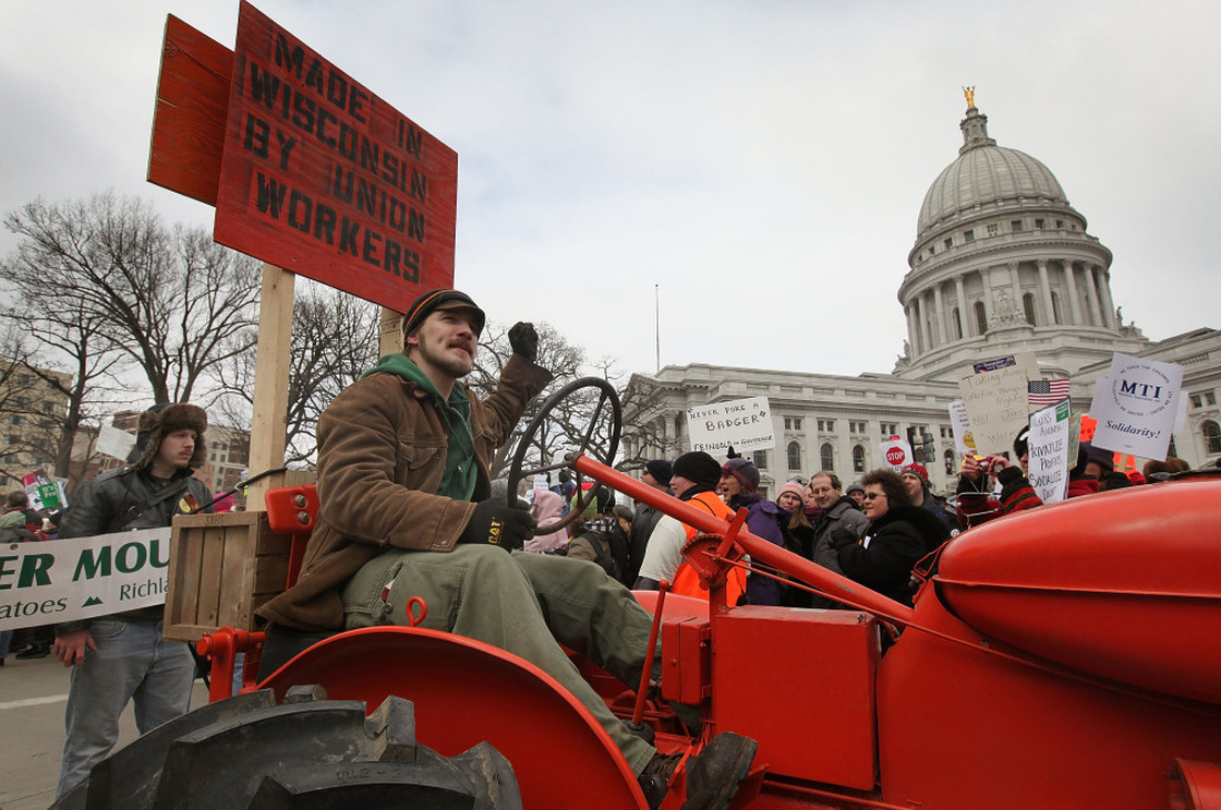 A farmer drives his tractor past the Wisconsin State Capitol during a rally in March.