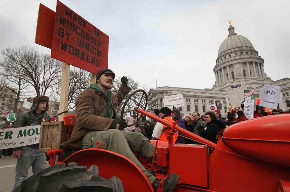 A farmer drives his tractor past the Wisconsin State Capitol during a rally in March.
