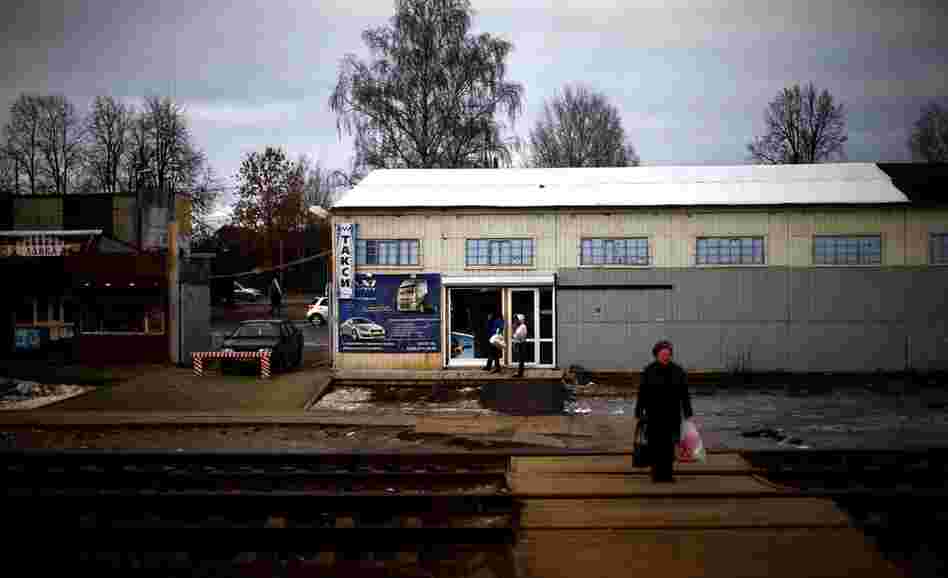 A woman waits for a local train at a small station along the Trans-Siberian railroad.