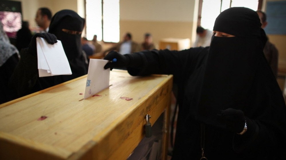 Nov. 28: Women place their votes in a ballot box at a polling station in a girls school in Cairo.