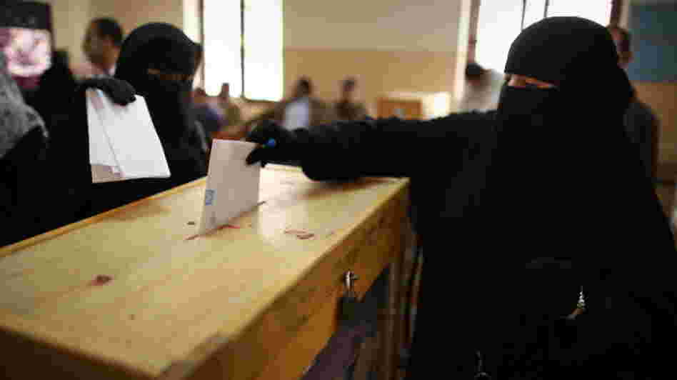 Nov. 28: Women place their votes in a ballot box at a polling station in a girls school in Cairo.