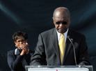 With his wife, Gloria, standing behind him, Herman Cain announces that he is suspending his presidential campaign, outside his campaign headquarters in Atlanta on Saturday. With his wife, Gloria, standing behind him, Herman Cain announces that he is suspending his presidential campaign, outside his campaign headquarters in Atlanta on Saturday.