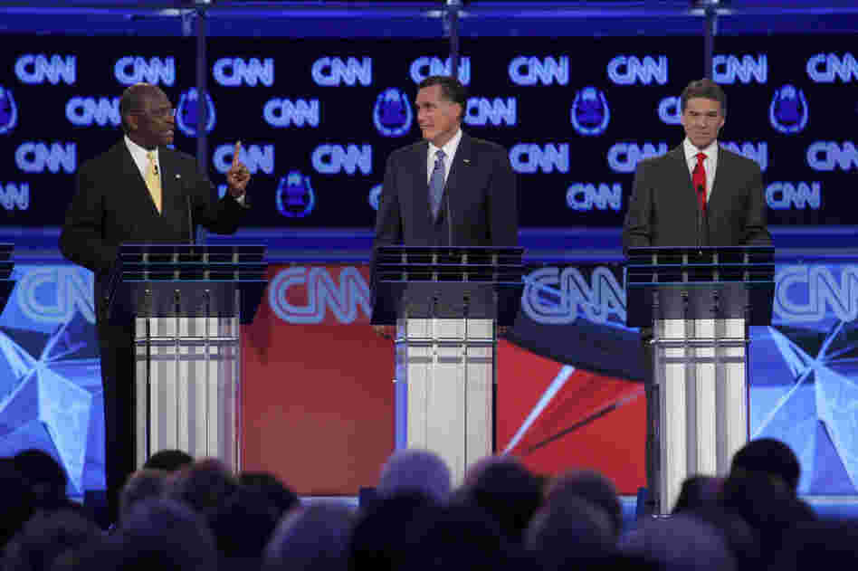 GOP presidential candidates Cain, former Massachusetts Gov. Mitt Romney (center) and Texas Gov. Rick Perry take part in the CNN debate in Las Vegas on Oct. 18. Cain was the front-runner in the polls at this time. 