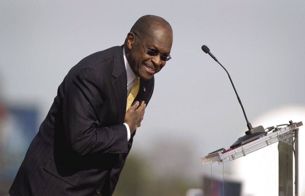 Herman Cain bows to the crowd during his announcement Saturday that he's suspending his campaign.