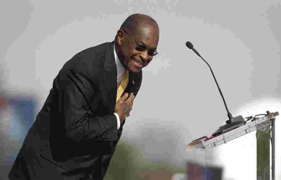 Herman Cain bows to the crowd during his announcement Saturday that he's suspending his campaign.