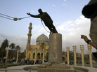 A U.S. marine watches a statue of Saddam Hussein being toppled in Firdaus Square, in downtown Baghdad, on April 9, 2003. A U.S. marine watches a statue of Saddam Hussein being toppled in Firdaus Square, in downtown Baghdad, on April 9, 2003.