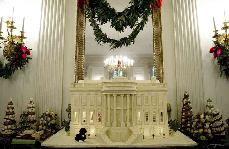 "Shine, Give, Share" is the theme for the Obama family's third Christmas in the White House. This year, a total of 37 Christmas trees and a 400-pound White House made of gingerbread, white chocolate and marzipan decorate the mansion. 