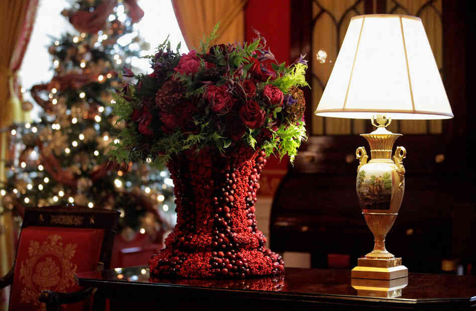 The Red Room features fruit, foliage and flowers set in berry-covered vases. 