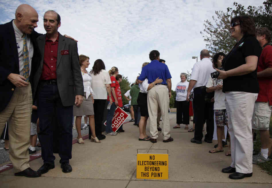 Former Maryland Gov. Bob Ehrlich (center, in the blue shirt) greets voters outside a polling place in Ellicott City, Md., in 2010. Ehrlich campaign manager Paul Schurick is now facing charges for allegedly discouraging voters from going to the polls on Election Day.