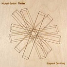 A wooden box houses the album called Timber by Michael Gordon. A wooden box houses the album called Timber by Michael Gordon.