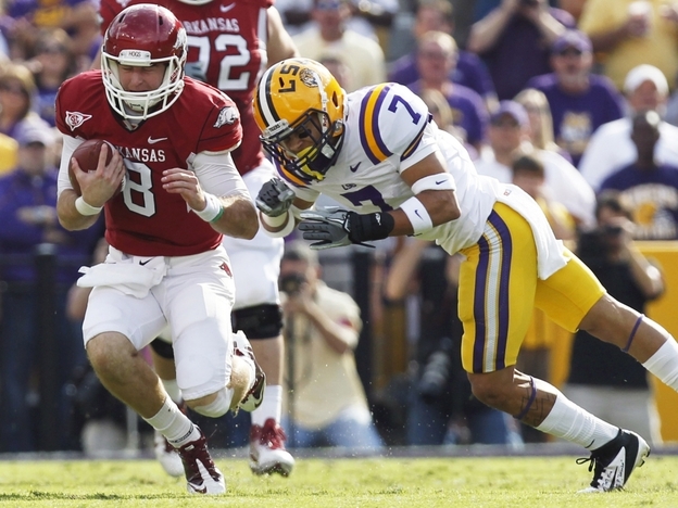 LSU cornerback Tyrann Mathieu (right) earned the nickname "Honey Badger" for hits like this one, against Arkansas quarterback Tyler Wilson on Nov. 25, 2011. Mathieu is one of five finalists named Monday for the Heisman Trophy.