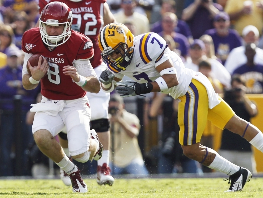 LSU cornerback Tyrann Mathieu (right) earned the nickname "Honey Badger" for hits like this one, against Arkansas quarterback Tyler Wilson on Nov. 25, 2011. Mathieu is one of five finalists named Monday for the Heisman Trophy.