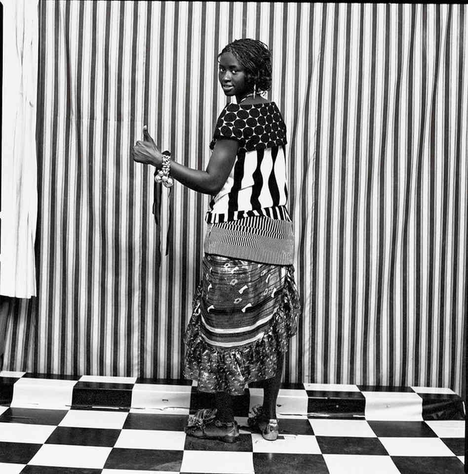 Assitan Sidibe in Marni polka-dot top, Christian Lacroix striped top, Marc Jacobs dress, and Christian Louboutin. Malick Sidibe, Courtesy Andre Magnin Assitan Sidibe in Marni polka-dot top, Christian Lacroix striped top, Marc Jacobs dress, and Christian Louboutin. Malick Sidibe, Courtesy Andre Magnin