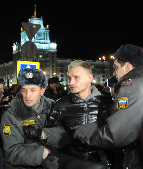 Police officers detain an opposition activist during an unauthorized rally in central Moscow, Tuesday. Police officers detain an opposition activist during an unauthorized rally in central Moscow, Tuesday.