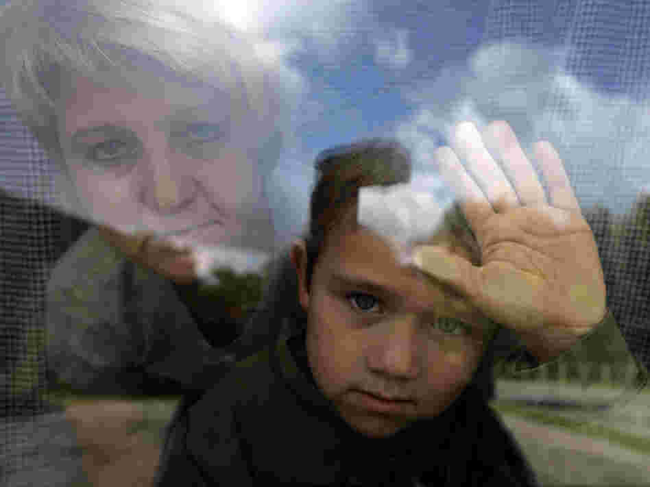 Janina Wasilewski, 41, and Brian, 6, look out one of their few windows in their tiny Polish apartment on Wednesday, Sept. 19, 2007 in Nowe Miasto Lubaswskie.