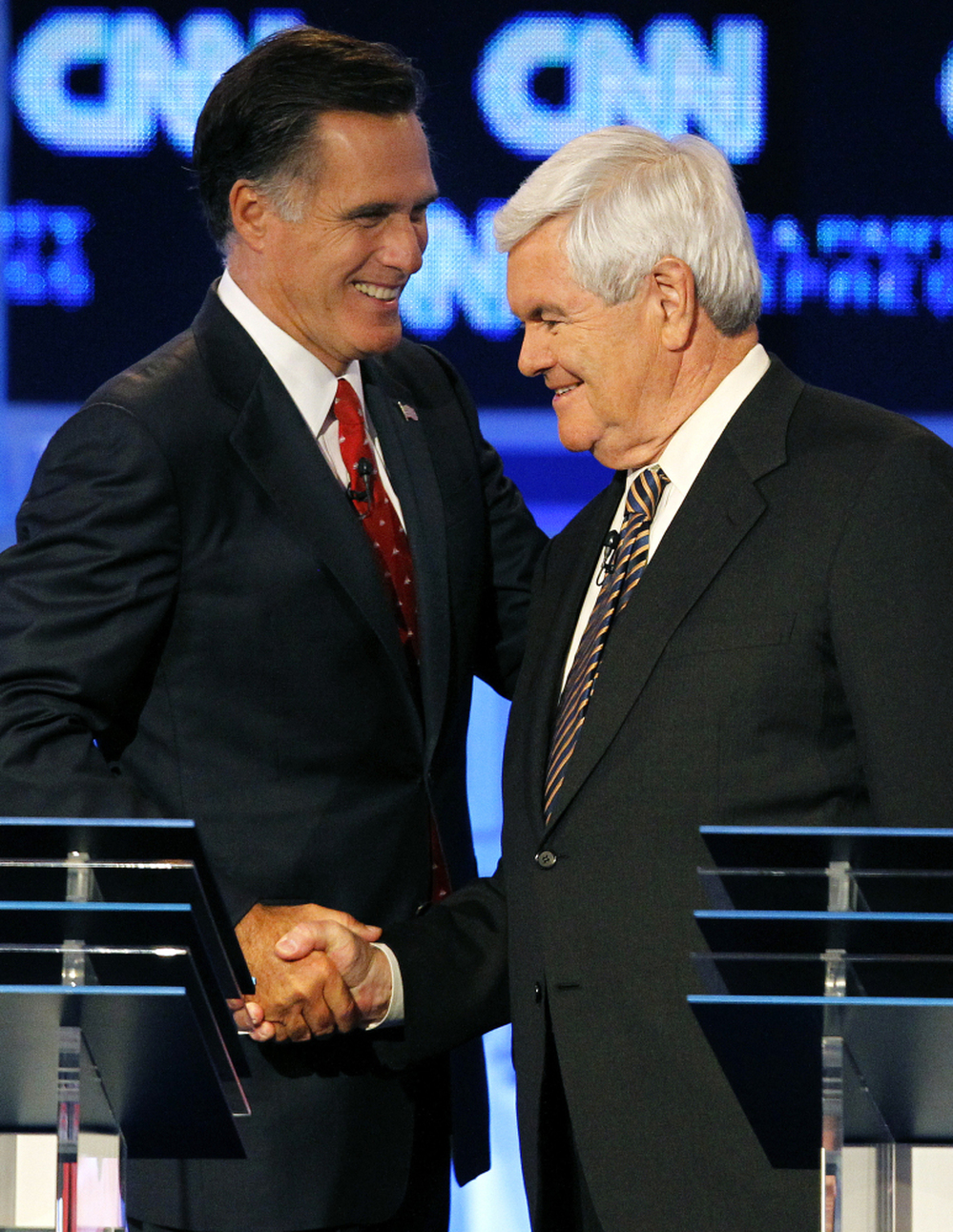 Republican presidential candidates Mitt Romney (left) and Newt Gingrich shake hands after a Republican presidential debate in Tampa, Fla.