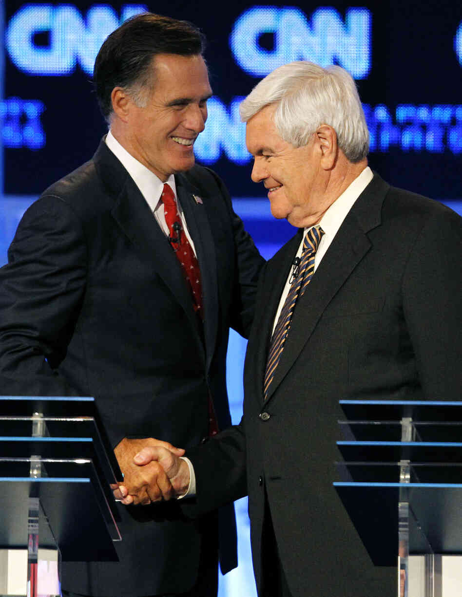 Republican presidential candidates Mitt Romney (left) and Newt Gingrich shake hands after a Republican presidential debate in Tampa, Fla.