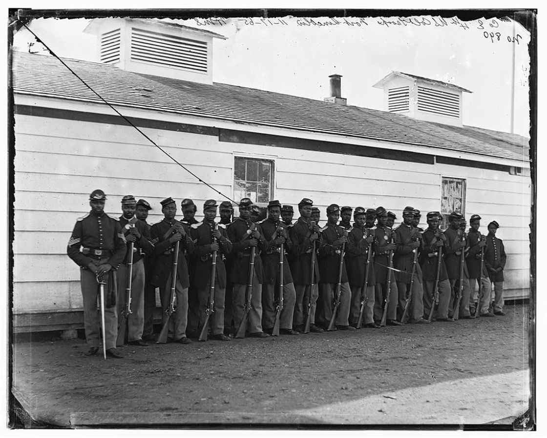 Soldiers of the 4th U.S. Colored Infantry Regiment, E Company, pose for a photograph at Fort Lincoln, Md., one of several fortifications ringing Washington, D.C., during the Civil War.