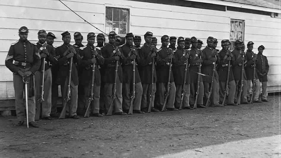 Soldiers of the 4th U.S. Colored Infantry Regiment, E Company, pose for a photograph at Fort Lincoln, Md., one of several fortifications ringing Washington, D.C., during the Civil War.