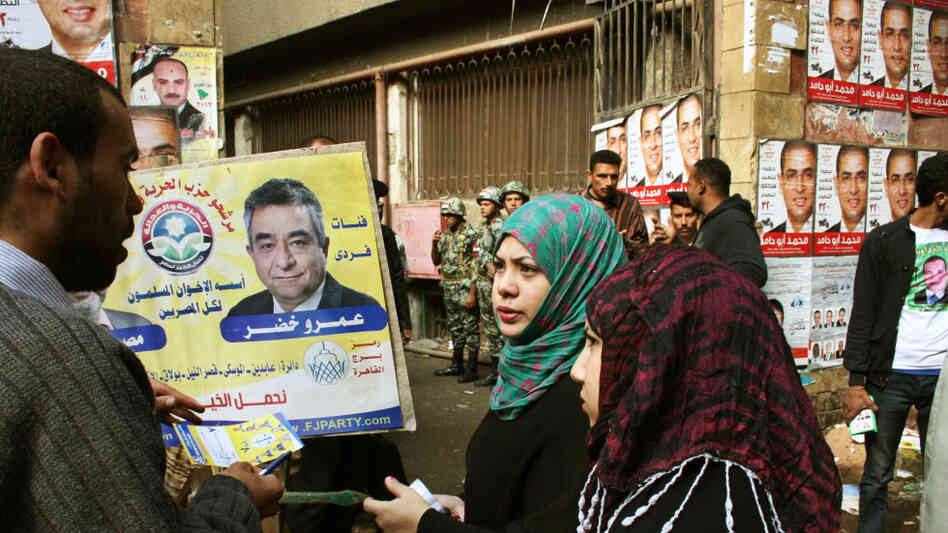 A campaigner for the Muslim Brotherhood's Freedom and Justice Party talks to voters in front of a polling station in Cairo on Nov. 28.