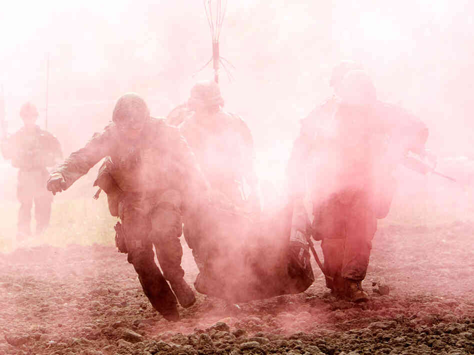 US Marines carry a wounded comrade who has been hit by an Improvised Explosive Device (IED) to a Medevac helicopter of U.S. Army's Task Force Lift "Dust Off", Charlie Company 1-171 Aviation Regiment in Helmand province on November 10, 2011. US Marines carry a wounded comrade who has been hit by an Improvised Explosive Device (IED) to a Medevac helicopter of U.S. Army's Task Force Lift "Dust Off", Charlie Company 1-171 Aviation Regiment in Helmand province on November 10, 2011.