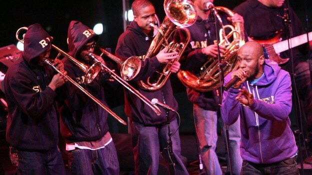 Rapper Mos Def performs with his big band project, an ensemble with traditional jazz instrumentation.
