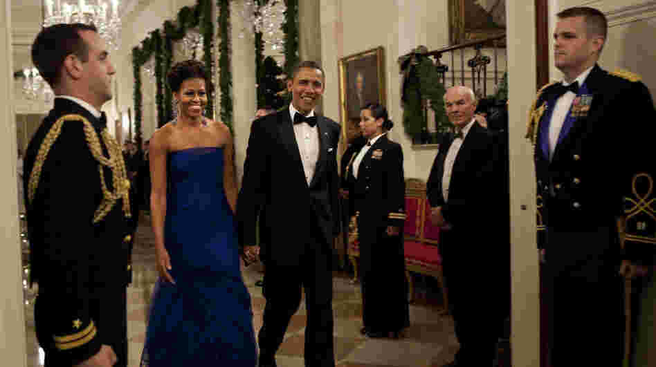 For a formal gathering, Michelle Obama demonstrates her sophistication in this elegant deep blue gown. 