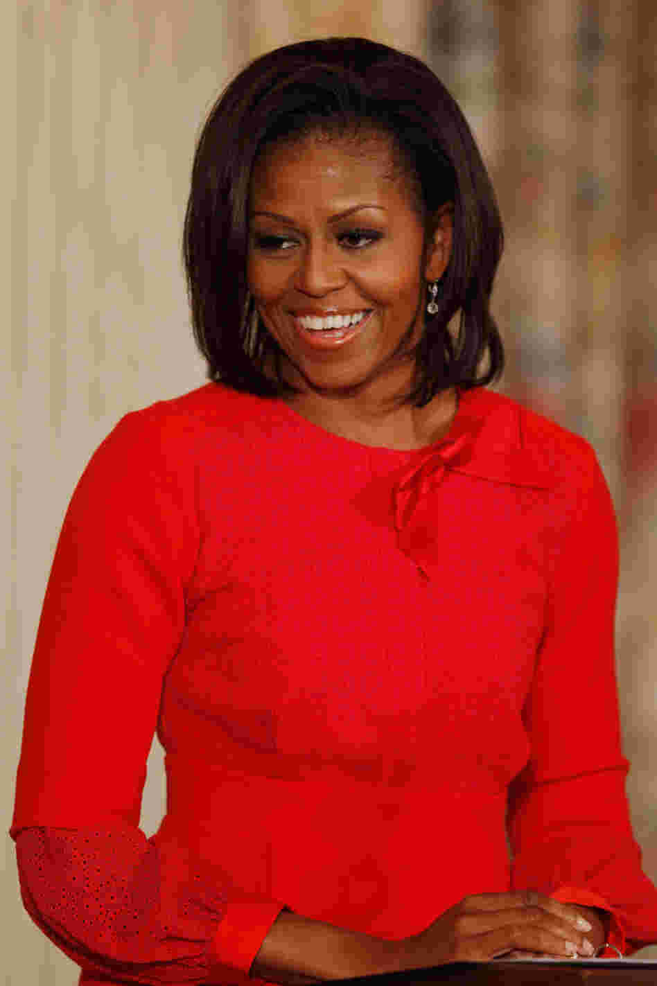 Michelle Obama shines in vivid red. 