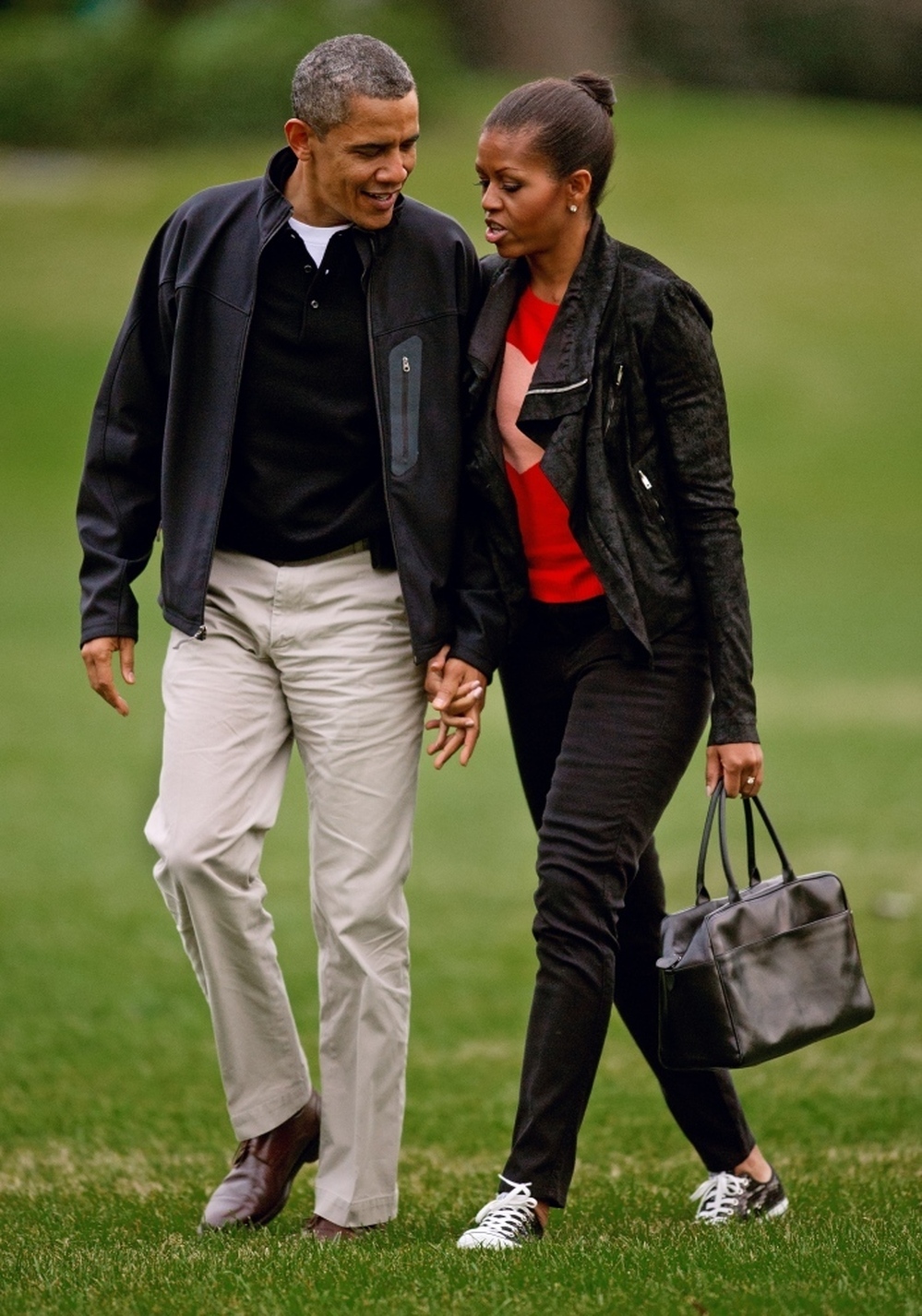 Michelle Obama sports casual skinny black pants and a matching jacket. 