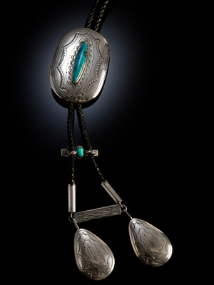 This silver and turquoise Navajo bolo tie was created in the early 1980s. This silver and turquoise Navajo bolo tie was created in the early 1980s.