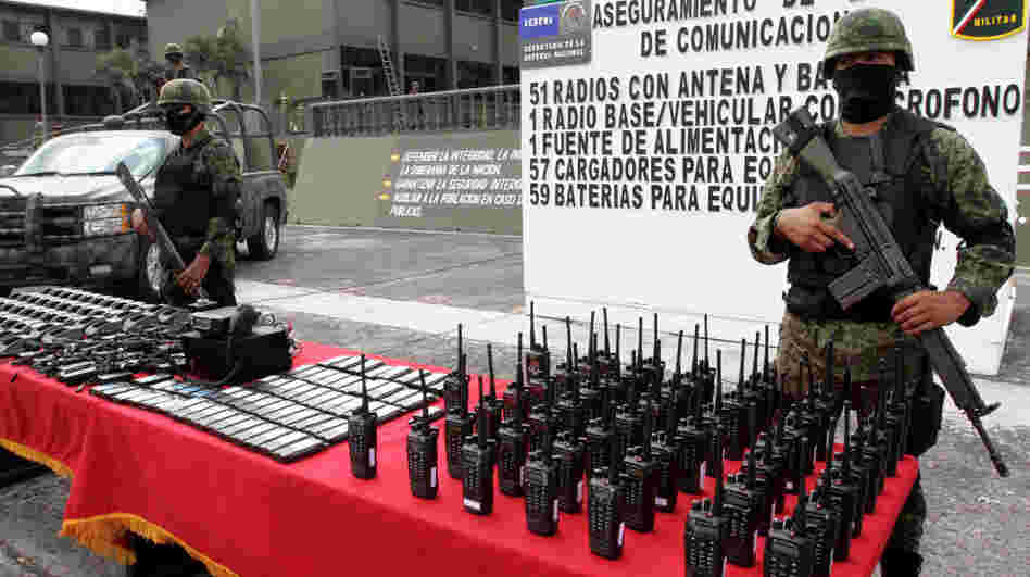 Mexican soldiers stand guard behind communication radios seized from alleged drug cartel members in Veracruz, Mexico, Nov. 23. 