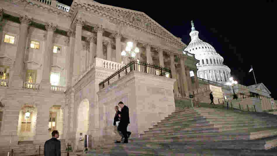 Congressmen walk down the steps of the House of Representatives as they work overnight on a spending bill in February.