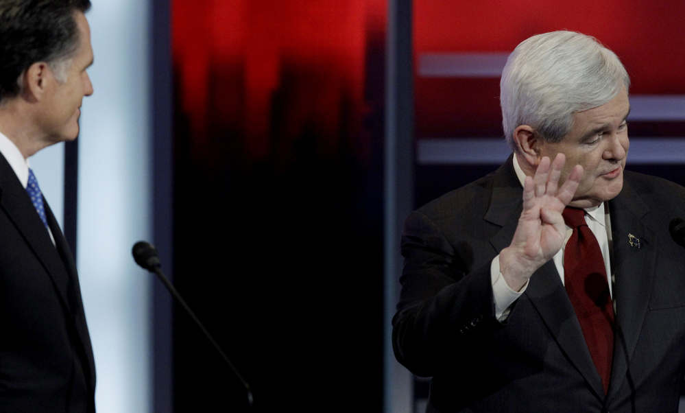 Mitt Romney and Newt Gingrich in a debate give and take, Saturday, Dec. 10, 2011, in Des Moines, Iowa. 