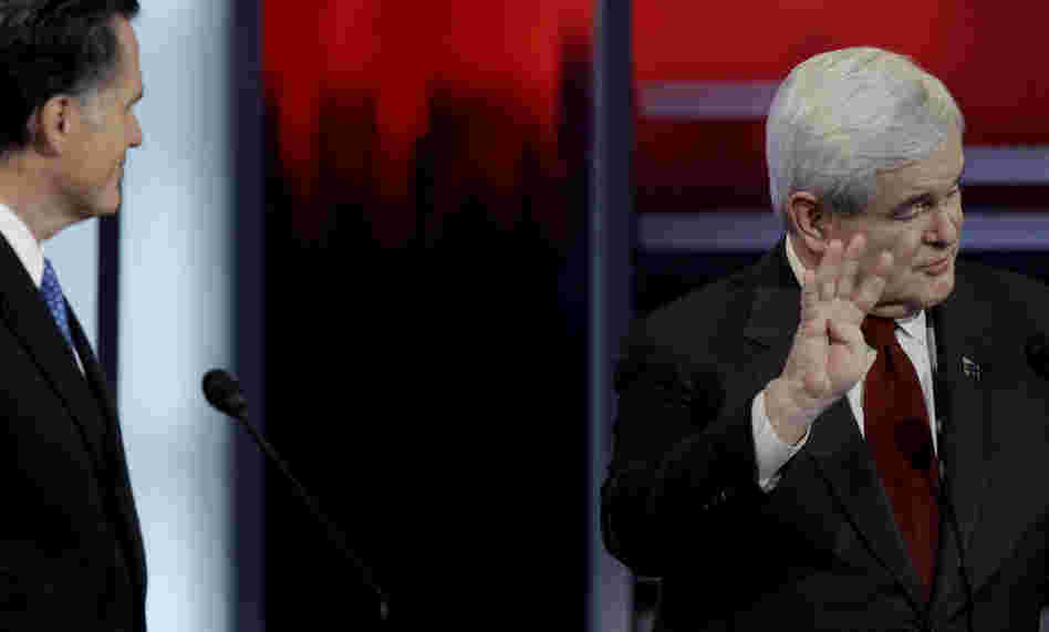 Mitt Romney and Newt Gingrich in a debate give and take, Saturday, Dec. 10, 2011, in Des Moines, Iowa. 
