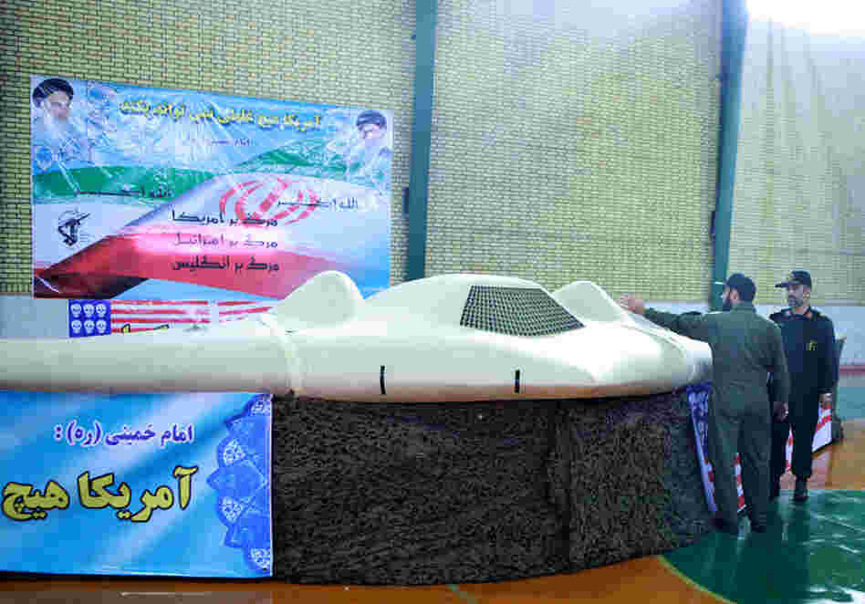 A picture released by the official website of Iran's Revolutionary Guards on December 8, 2011 shows Iranian Revolutionary Guard, Brig. Gen. Amir-Ali Hajizadeh (R) looking at what Iranian officials claim is a U.S. RQ-170 Sentinel high-altitude reconnaissance drone that crashed in Iran on December 4.