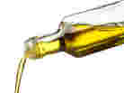 olive oil being poured from glass bottle