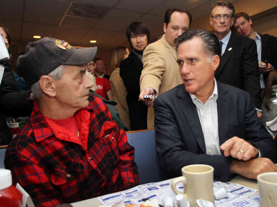 Mitt Romney talks to Bob Garon at at Chez Vachon Restaurant, Monday, Dec. 12, 2011.