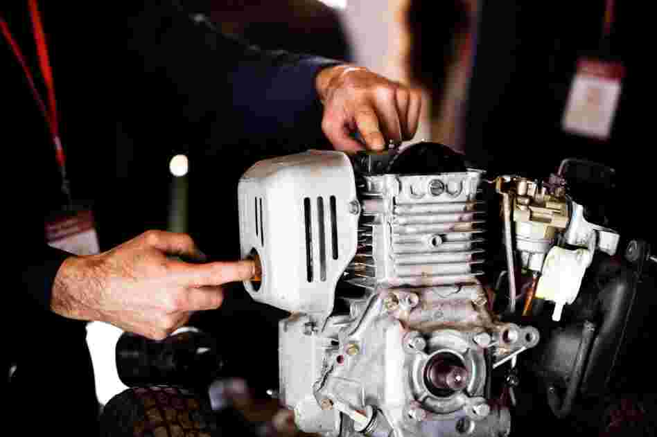 Stone Barns mechanic John Di Marco teaches a group of young farmers about fixing small engines.