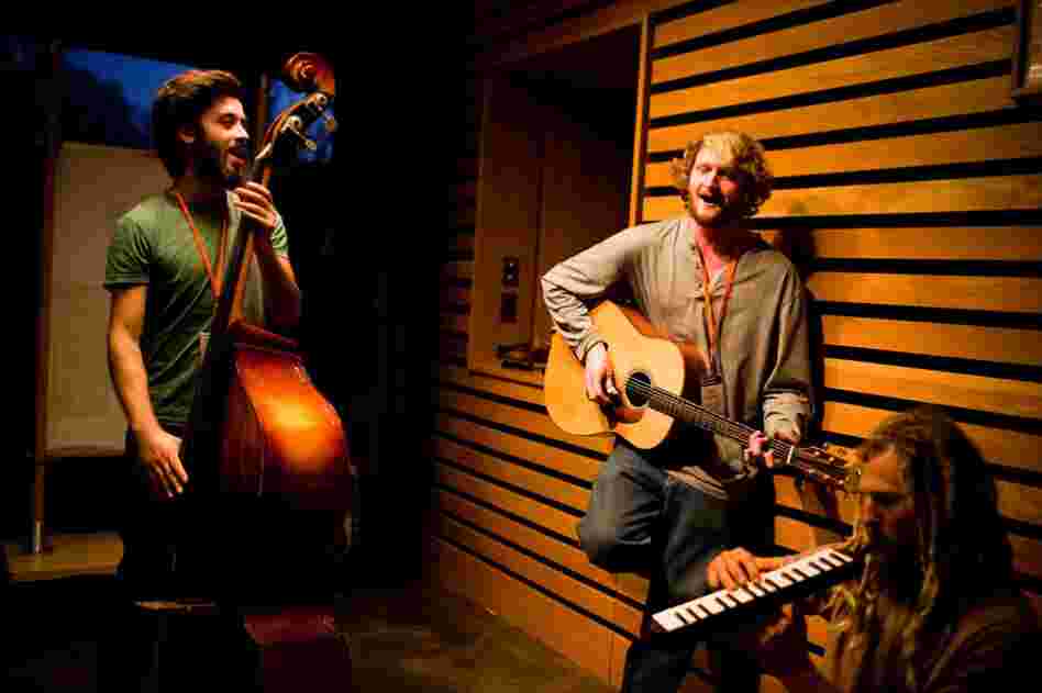 From left: Farmers Nate Kraus-Malett, Max Godfrey and Steven "Shepsi" Eaton prepare to play their instruments at a nighttime dance at the conference.