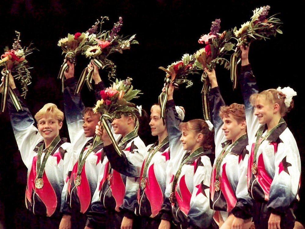 Dawes and her teammates, known as the "Magnificent Seven," wave to the crowd after being awarded their gold medals in the team competition at the 1996 Summer Games in Atlanta.