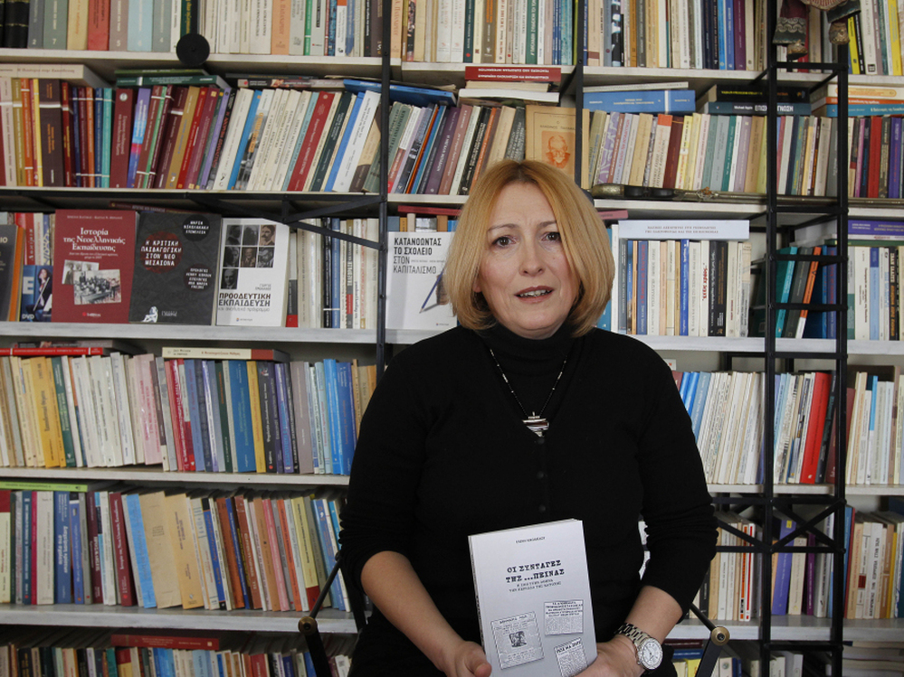 Historian and cookbook author Eleni Nikolaidou with her book Starvation Recipes. Recession-hit Greeks are fascinated with the book's World War II-era survival tips and recipes.