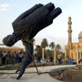 U.S. troops topple a statue of Saddam Hussein on April 9, 2003, the 21st day of Operation Iraqi Freedom, in central Baghdad.