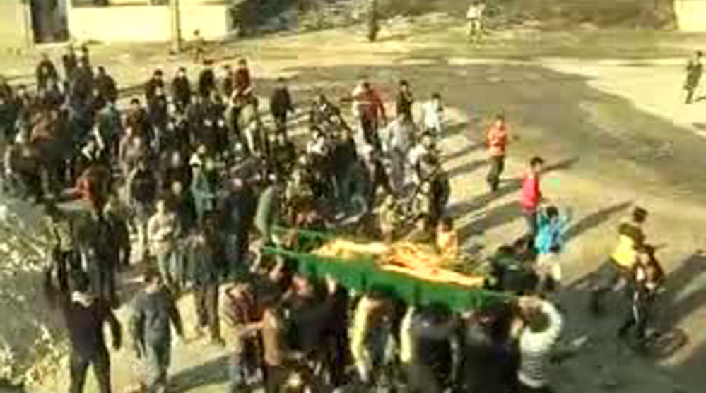 An image grab taken from a video uploaded on YouTube shows Syrian mourners carrying the coffin of a woman who was reportedly killed in the al-Hula region of central Homs province on December 12, 2011.