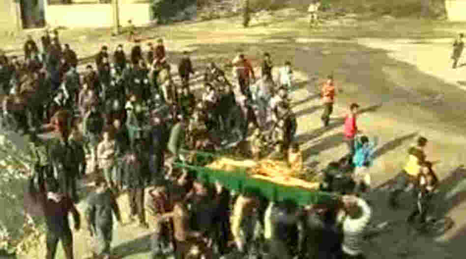 An image grab taken from a video uploaded on YouTube shows Syrian mourners carrying the coffin of a woman who was reportedly killed in the al-Hula region of central Homs province on December 12, 2011.