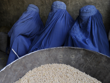 Burqa-clad Afghan women wait to buy chickpeas from a shop in Kabul earlier this year. Burqa-clad Afghan women wait to buy chickpeas from a shop in Kabul earlier this year.