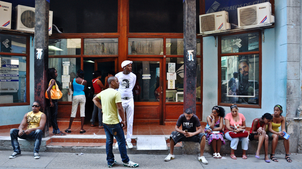 Cubans wait to go online at an Internet cafe in Havana earlier this year. The Cuban government announced months ago that a new fiber-optic cable to Venezuela would improve Internet access and speeds, but that still hasn't happened. 