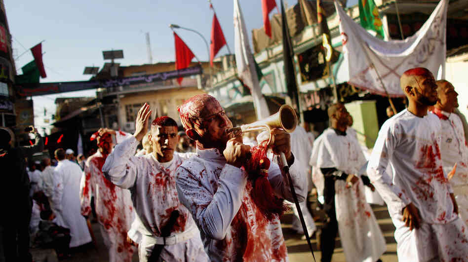 Shiite worshipers march after cutting their scalps in a ritual display of mourning during an Ashura ceremony outside Kadhimiya shrine in Baghdad on Dec. 6. Shiite festivals such as this were prohibited under dictator Saddam Hussein, a Sunni. Shiite Iran is seeking greater influence in Iraq, and Iraq's Sunni neighbors are doing the same. 