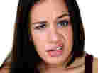 A woman making a disgusted face.