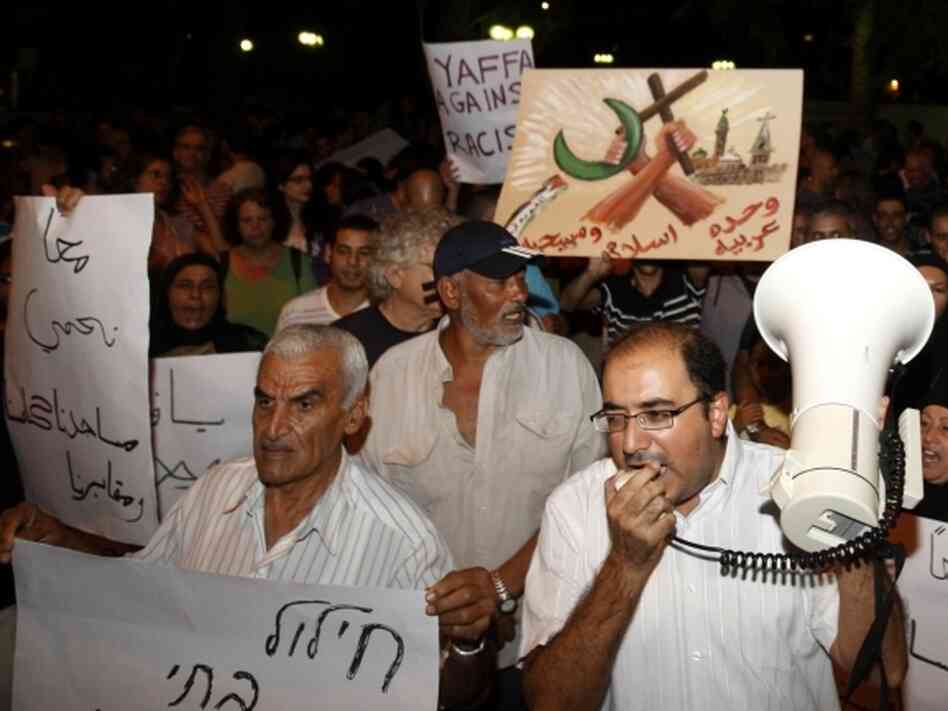  Israelis and Palestinians protest after two cemeteries, one Muslim and the other Christian, were vandalized by graffiti in the Arab city of Jaffa, near Tel Aviv, in October.